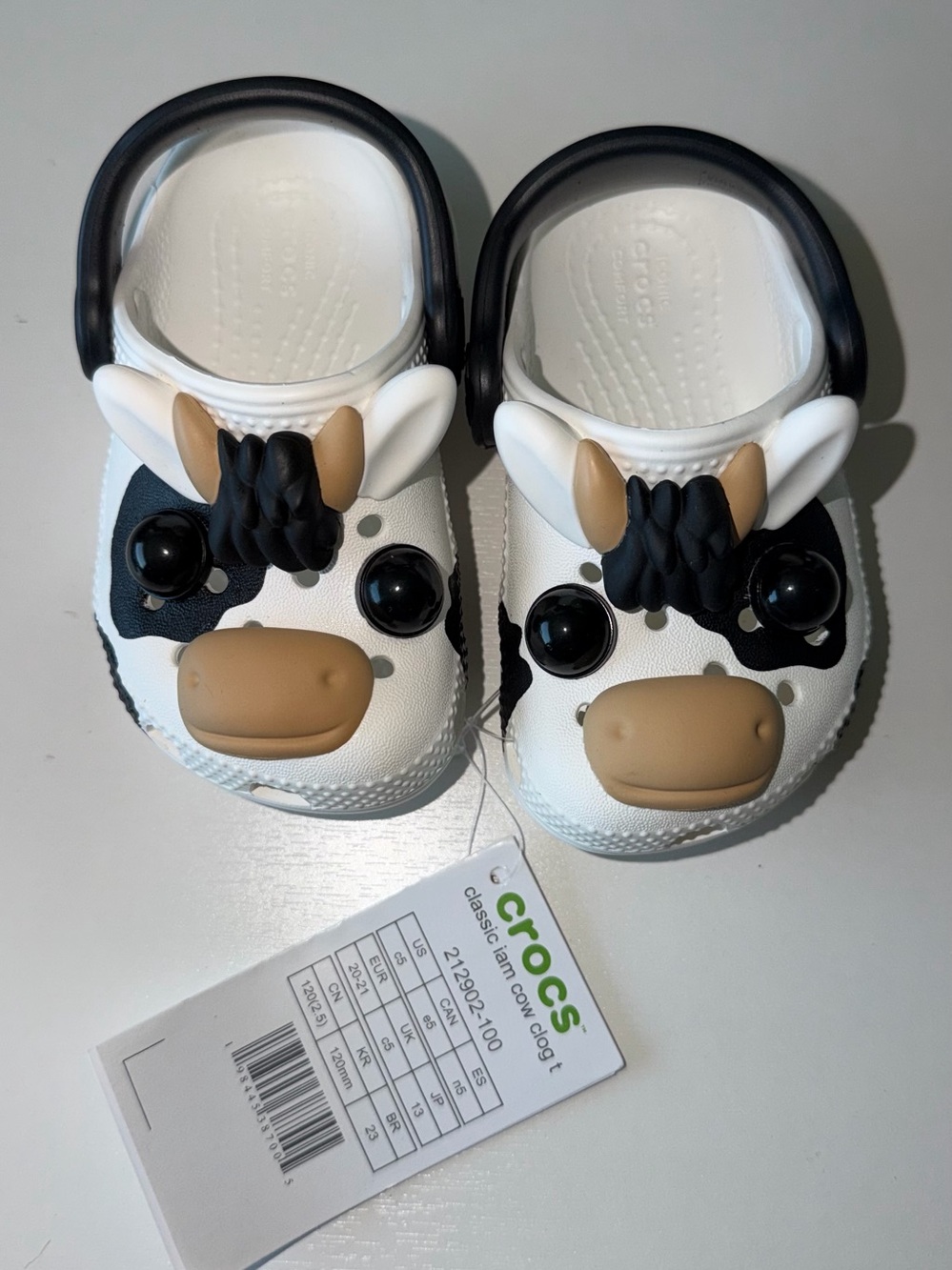 CROCS Kids Cow-Themed Clog in White, Black & Tan